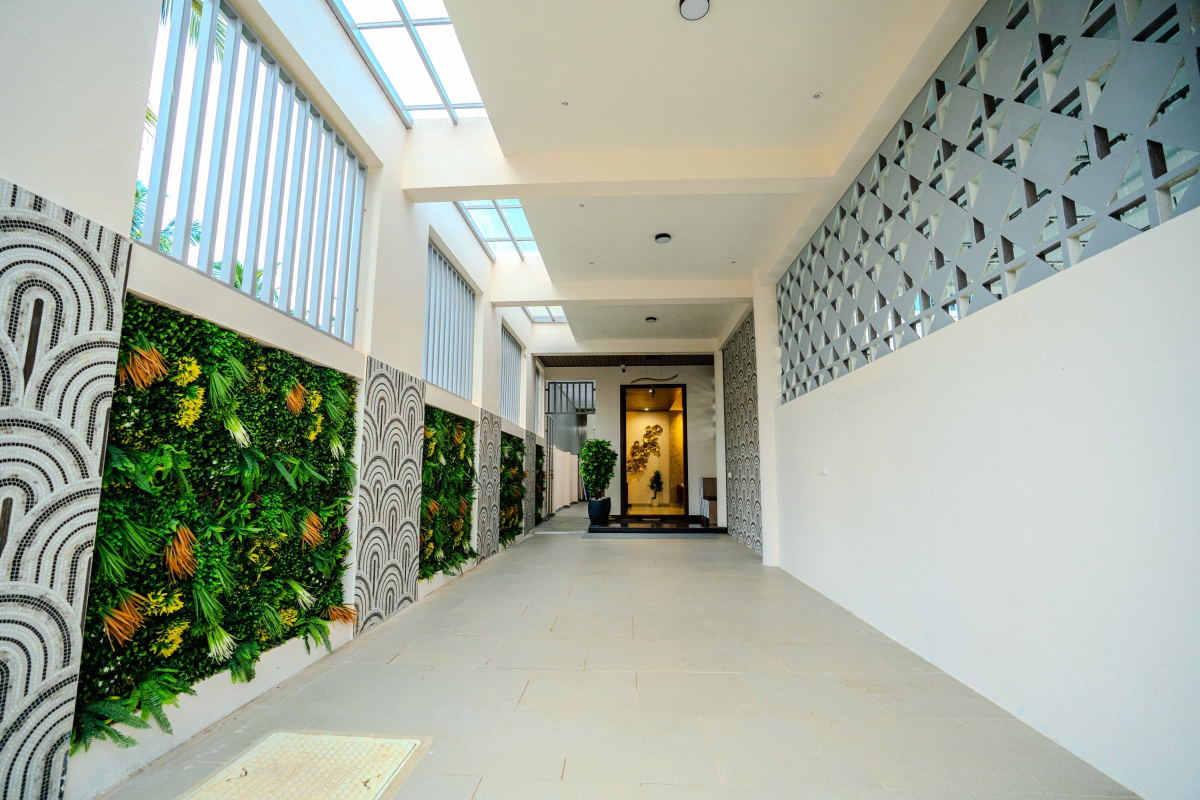 Villa entrance with a lit wooden front door