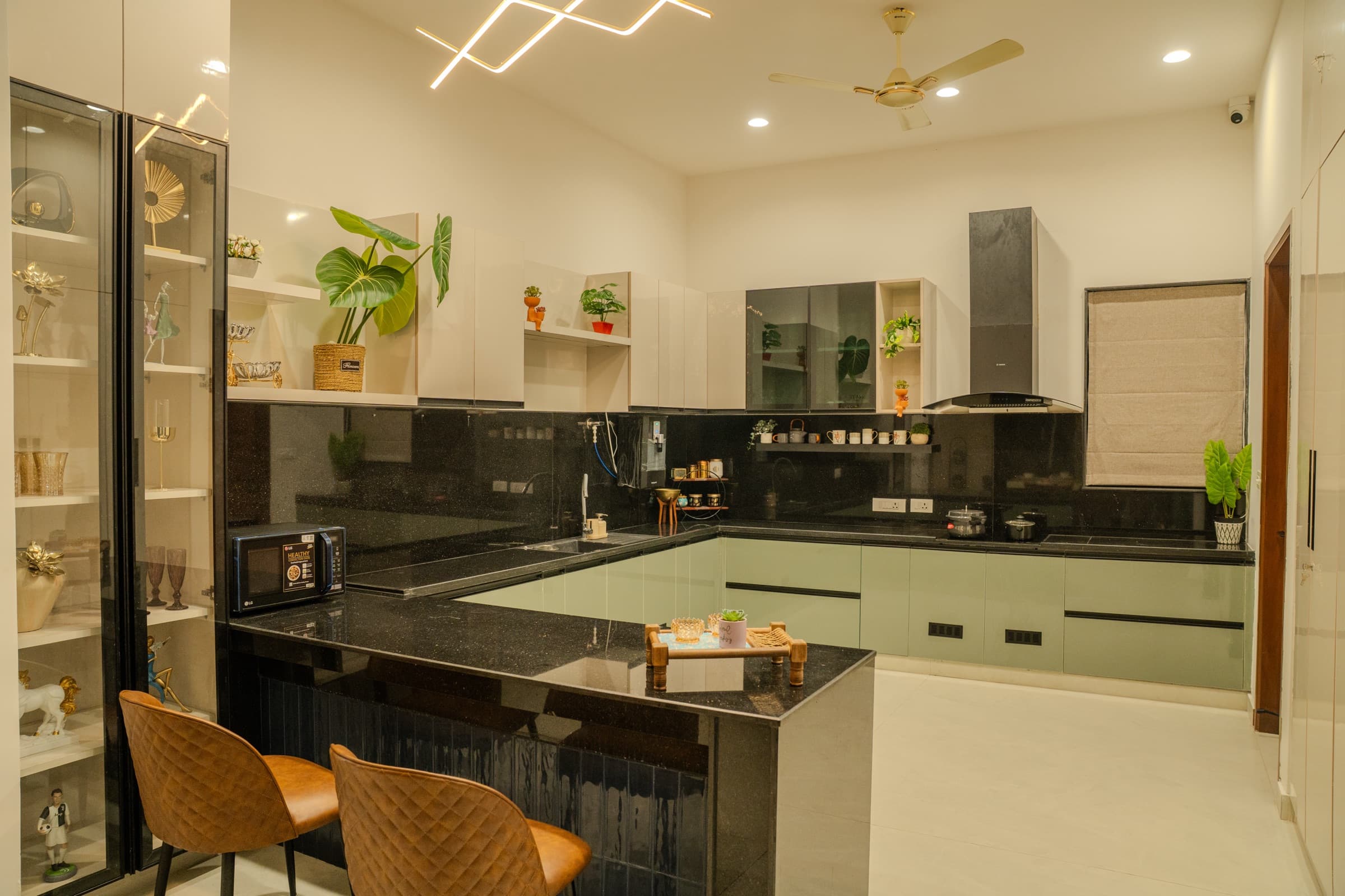 Open kitchen with a stone island and oak cabinetry